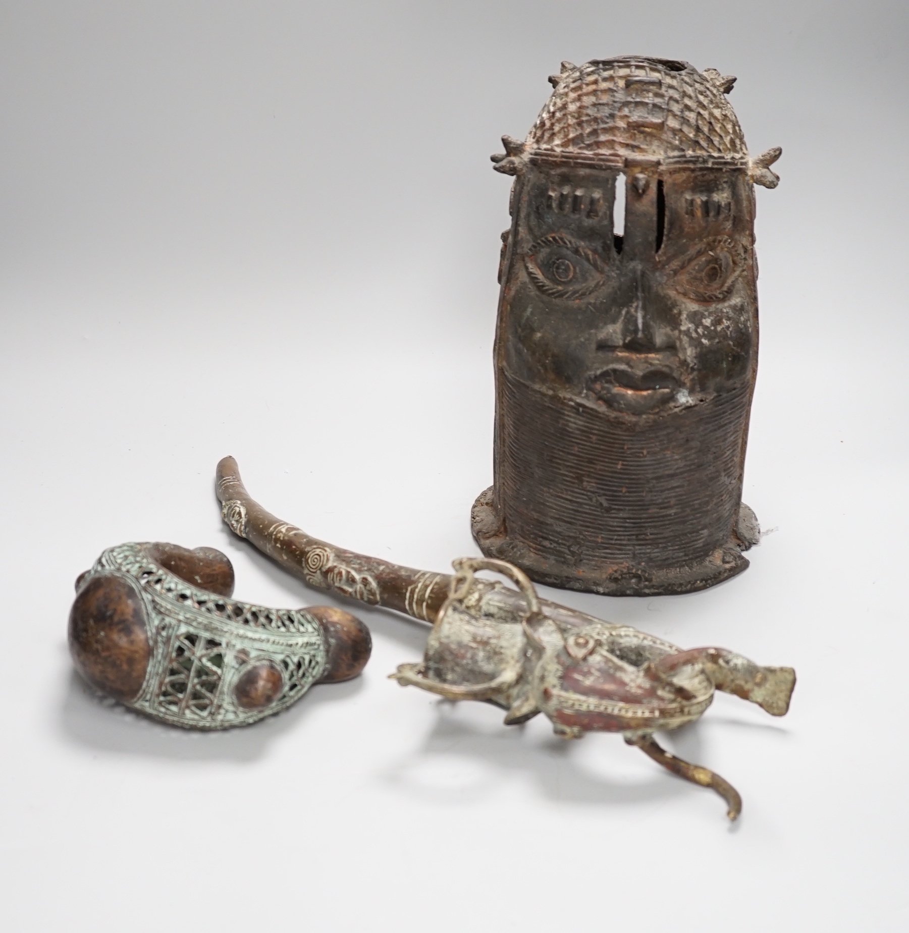 West African bronzes: Benin, a male and a female head, bangle anklet, a ceremonial pipe, ornamental ladle (5)